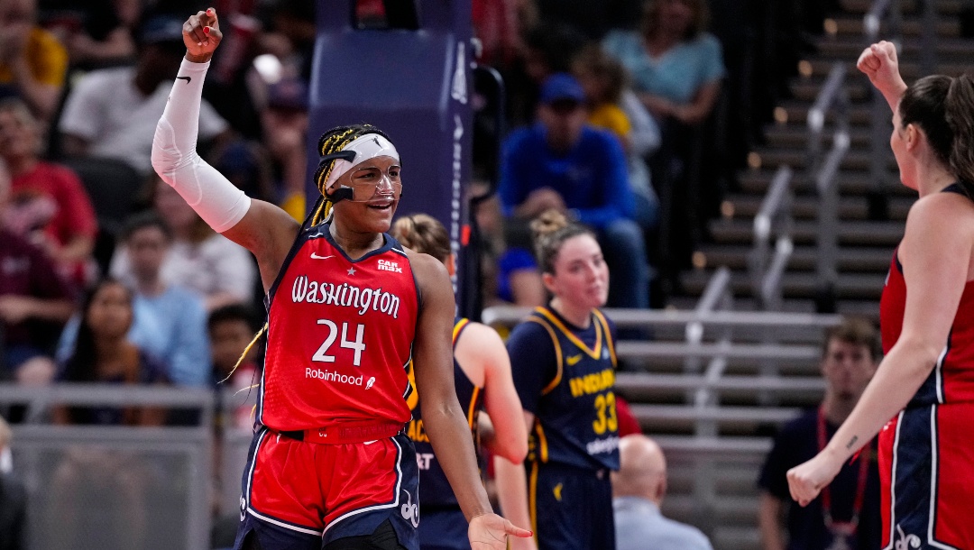 Washington Mystics forward Aaliyah Edwards (24) signals to count the basket after she was fouled by the Indiana Fever in the first half of a WNBA basketball game in Indianapolis, Wednesday, July 10, 2024.