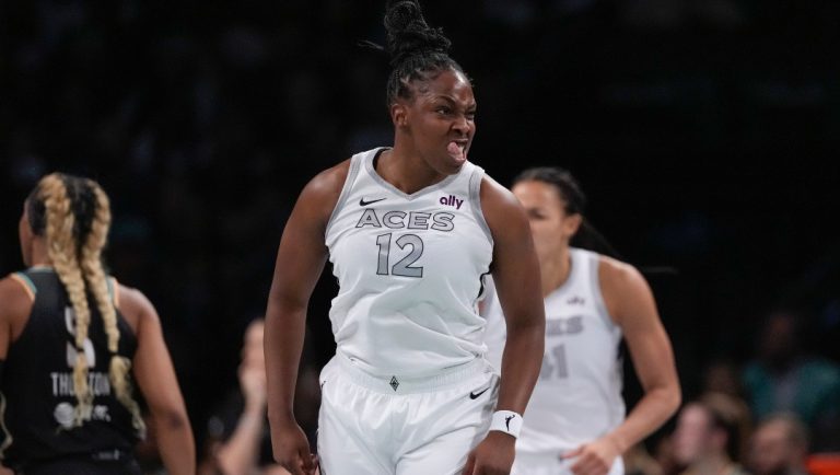 Las Vegas Aces' Chelsea Gray (12) gestures after scoring during the first half of a WNBA basketball semifinal game against the New York Liberty, Tuesday, Oct. 1, 2024, in New York.