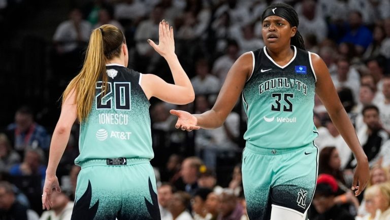New York Liberty forward Jonquel Jones (35) celebrates her 3-point basket against the Minnesota Lynx with guard Sabrina Ionescu (20) during the second half of Game 4 of a WNBA basketball final playoff series, Friday, Oct. 18, 2024, in Minneapolis.