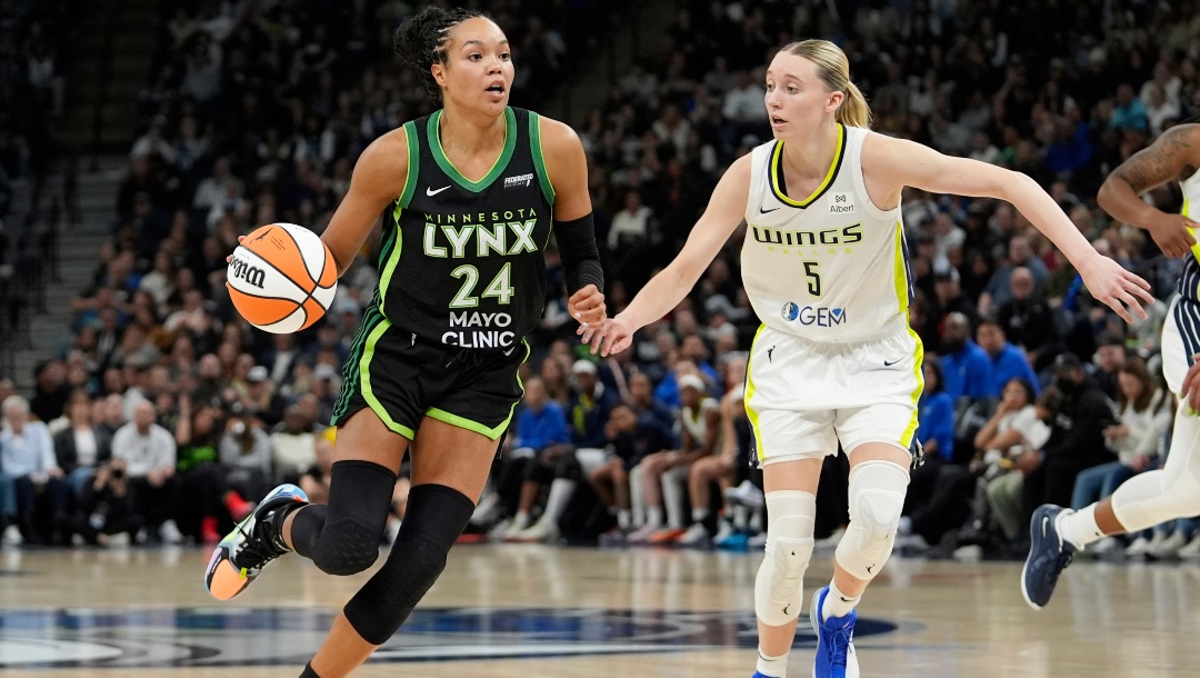 Minnesota Lynx forward Napheesa Collier (24) dribbles down the court as Dallas Wings guard Paige Bueckers (5) defends during the second half of a WNBA basketball game Wednesday, May 21, 2025, in Minneapolis.