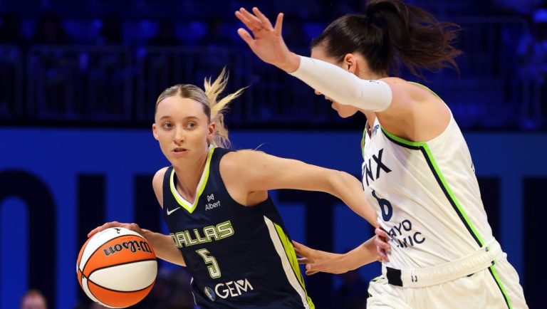 Dallas Wings guard Paige Bueckers (5) drives past Minnesota Lynx forward Bridget Carleton (6) in the second half of a WNBA basketball game Friday, May 16, 2025, in Arlington, Texas.