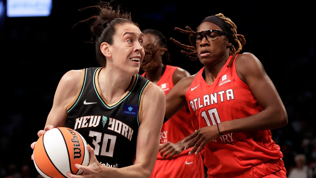 New York Liberty forward Breanna Stewart (30) drives past Atlanta Dream guard Rhyne Howard during the first half of a first-round WNBA basketball playoff game, Tuesday, Sept. 24, 2024, in New York.
