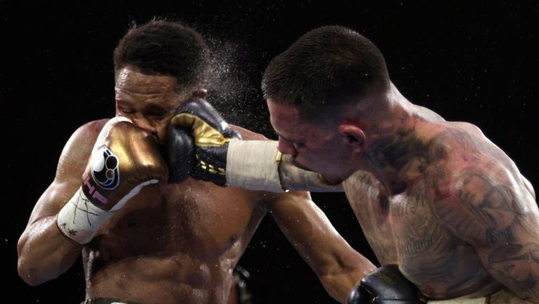 George Kambosos Jr. of Australia, right, lands a blow to the head of United States' Devin Haney as Haney defends his undisputed.
