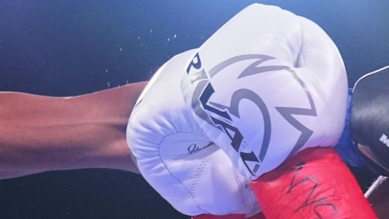 Zaquin Moses, left, punches Carl Rogers during the third round of a super featherweight boxing match Saturday, June 14, 2025.