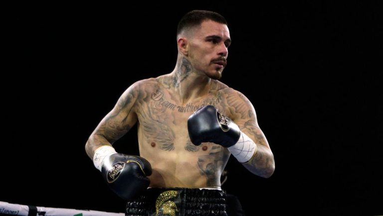 United States' Devin Haney, right, gets instructions from the referee while fighting George Kambosos Jr. of Australia.