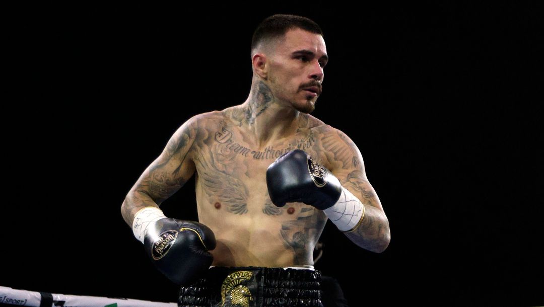 United States' Devin Haney, right, gets instructions from the referee while fighting George Kambosos Jr. of Australia.