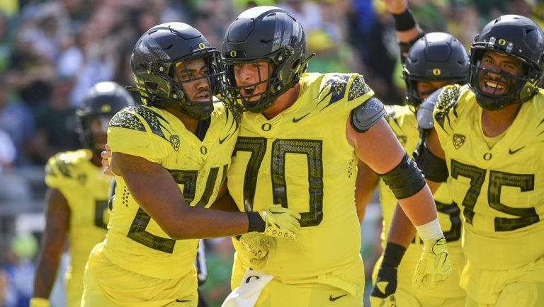 Oregon running back Dante Dowdell (24 celebrates his touchdown against Portland State with offensive lineman Charlie Pickard (70) and offensive lineman Faaope Laloulu (75) during the second half of an NCAA college football game Saturday, Sept. 2, 2023, in Eugene, Ore.
