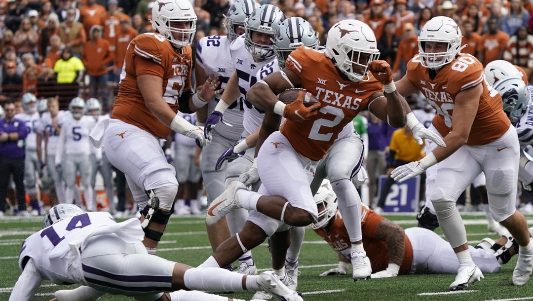 Texas running back Roschon Johnson (2) runs against Kansas State during the first half of an NCAA college football game in Austin, Texas, Friday, Nov. 26, 2021.