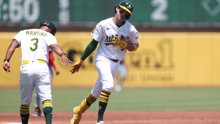 Athletics' Jacob Wilson (5) celebrates with third base coach Eric Martins (3) after hitting a solo home run against the Minnesota Twins during the third inning of a baseball game, Thursday, June 5, 2025, in West Sacramento, Calif.