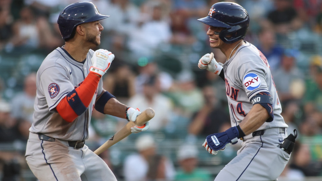 Houston Astros' Jeremy Peña, left, and Mauricio Dubón, right, celebrate Dubón solo home run against the Athletics during the fourth inning of a baseball game Tuesday, June 17, 2025, in West Sacramento, Calif.