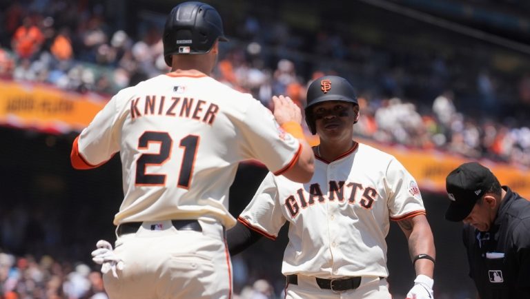 San Francisco Giants' Rafael Devers, right, celebrates after hitting a two-run home run that also scored Andrew Knizner (21) during the third inning of a baseball game against the Miami Marlins in San Francisco, Thursday, June 26, 2025.