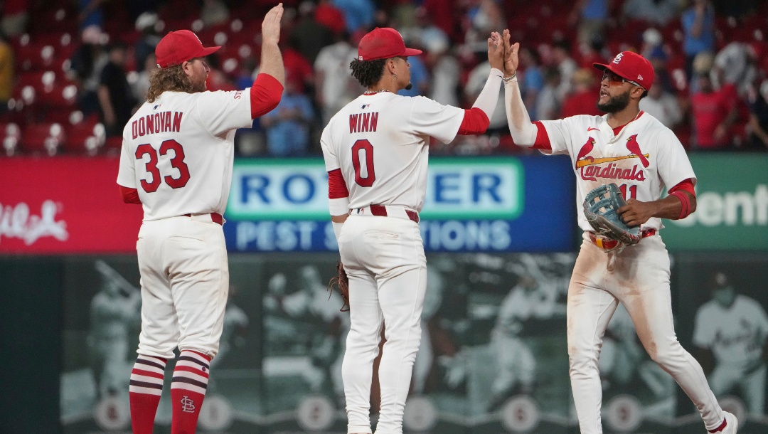 St. Louis Cardinals' Brendan Donovan (33), Masyn Winn (0) and Victor Scott II (11) celebrate a victory over the Chicago Cubs following a baseball game Monday, June 23, 2025, in St. Louis.