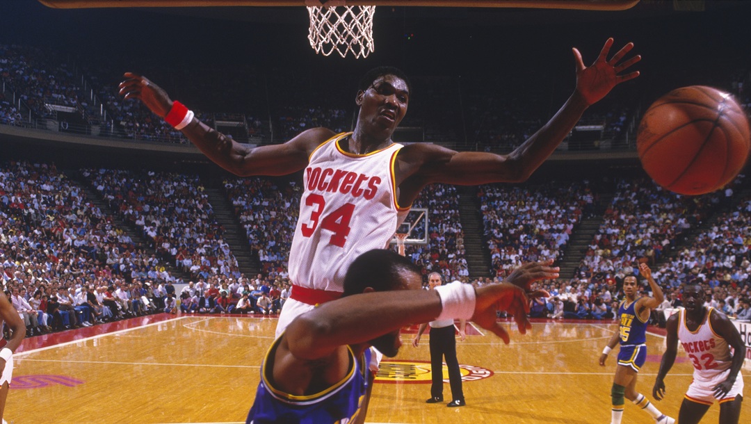 UNDATED: Hakeem Olajuwon #34 of the Houston Rockets blocks a shot from the Utah Jazz at The Compaq Center in Houston, Texas.