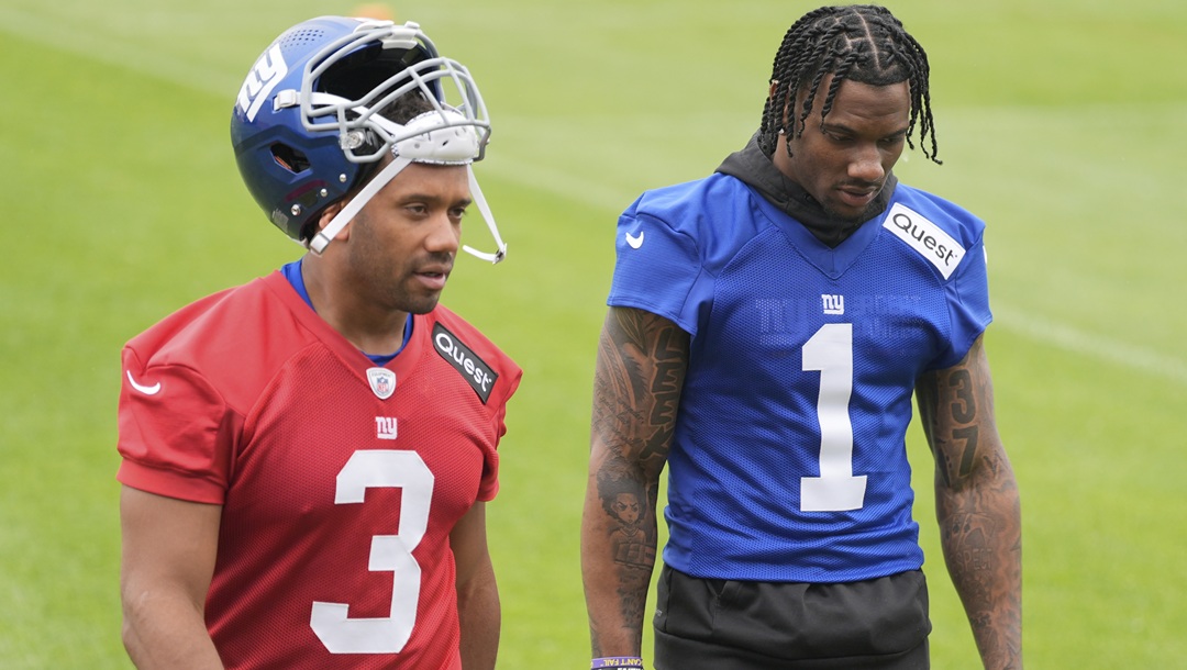 New York Giants' Malik Nabers, right, talks with quarterback Russell Wilson as they walk off the field after an NFL football practice in East Rutherford, N.J., Wednesday, May 28, 2025.