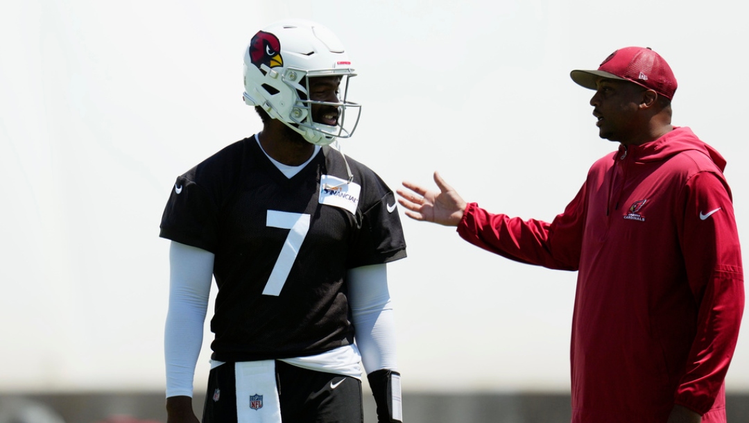 Arizona Cardinals quarterback Jacoby Brissett (7) talks with Cardinals quarterbacks coach Israel Woolfork during an NFL football practice Tuesday, June 3, 2025, in Tempe, Ariz.