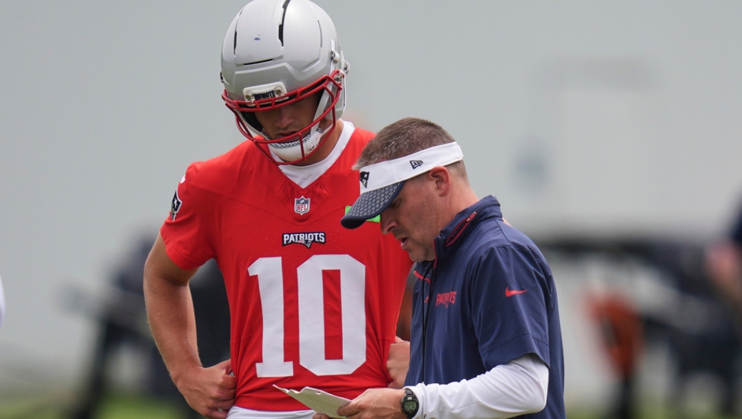 New England Patriots offensive coordinator Josh McDaniels, right, talks with quarterback Drake Maye (10) during an NFL football practice, Wednesday, May 28, 2025, in Foxborough, Mass.
