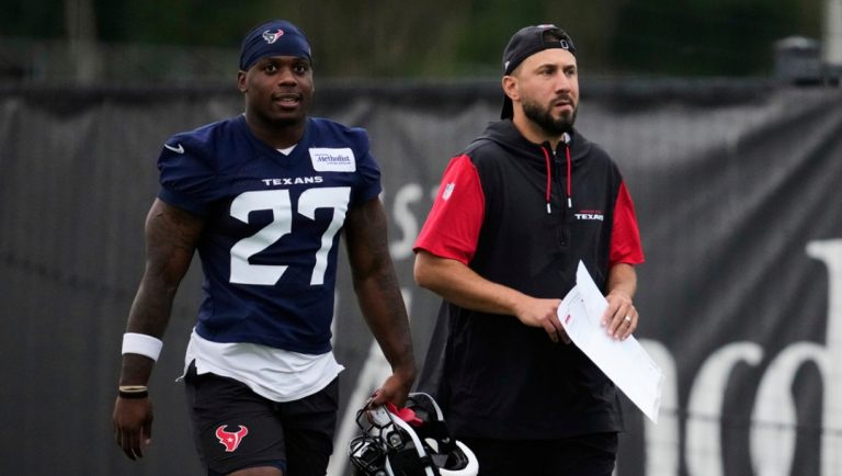 Houston Texans running back Woody Marks (27) walks with offensive coordinator Nick Caley during NFL football practice Friday, May 30, 2025, in Houston.