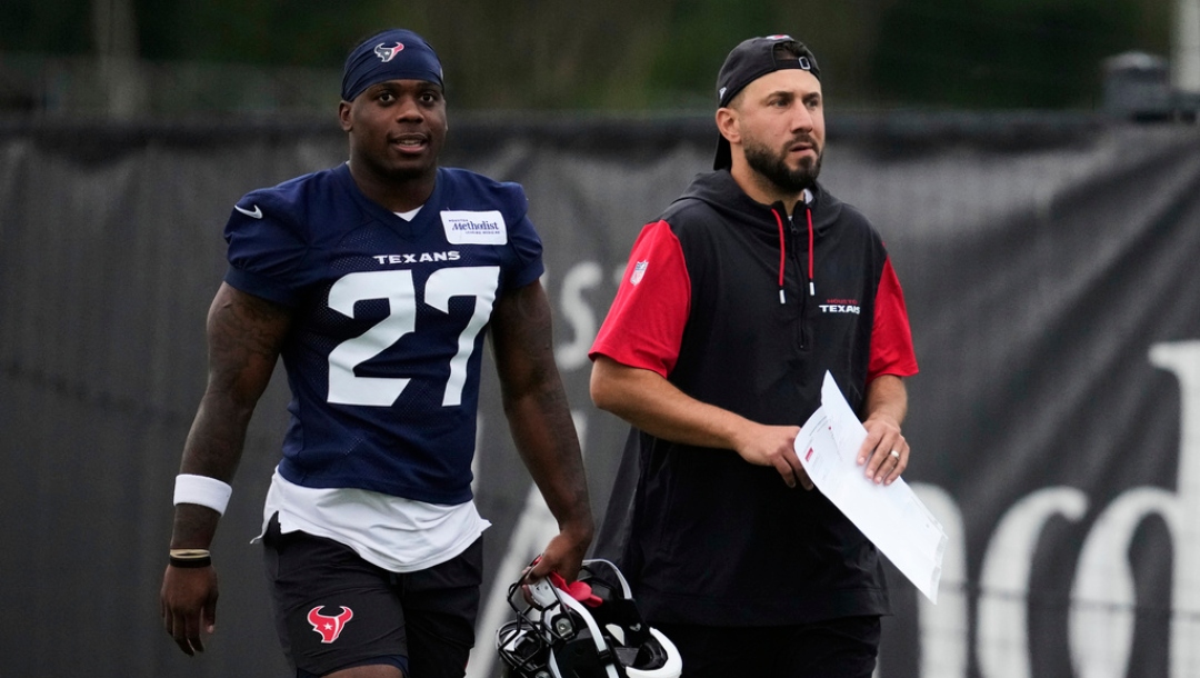 Houston Texans running back Woody Marks (27) walks with offensive coordinator Nick Caley during NFL football practice Friday, May 30, 2025, in Houston.