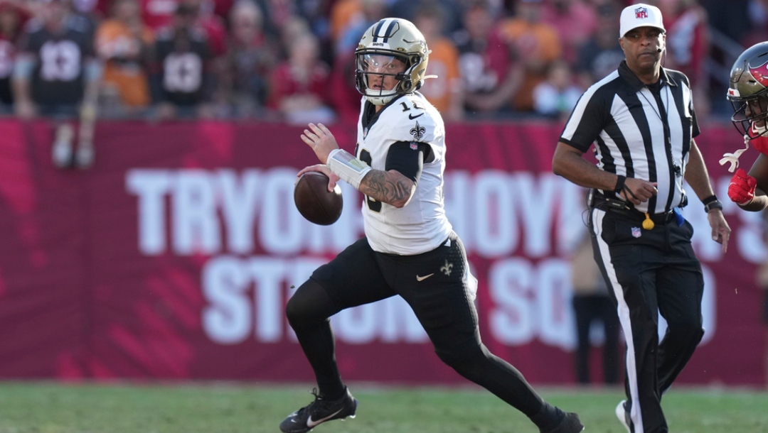 New Orleans Saints quarterback Spencer Rattler (18) looks downfield as he scrambles during an NFL football game against the Tampa Bay Buccaneers, Sunday, Jan 5, 2025, in Tampa, Fla.