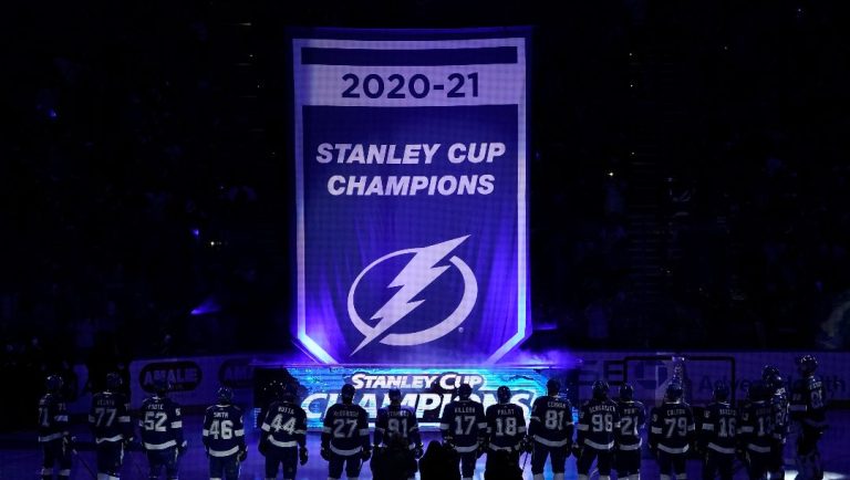The Tampa Bay Lightning raise their 2020-2021 Stanley Cup Champions banner before an NHL hockey game against the Pittsburgh Penguins Tuesday, Oct. 12, 2021, in Tampa, Fla.
