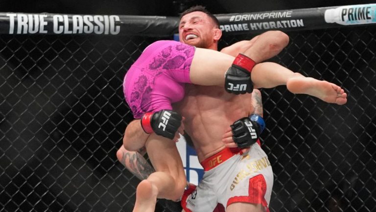 Georgia's Merab Dvalishvili grapples with Sean O'Malley during the third round of a bantamweight title bout at the UFC 316.