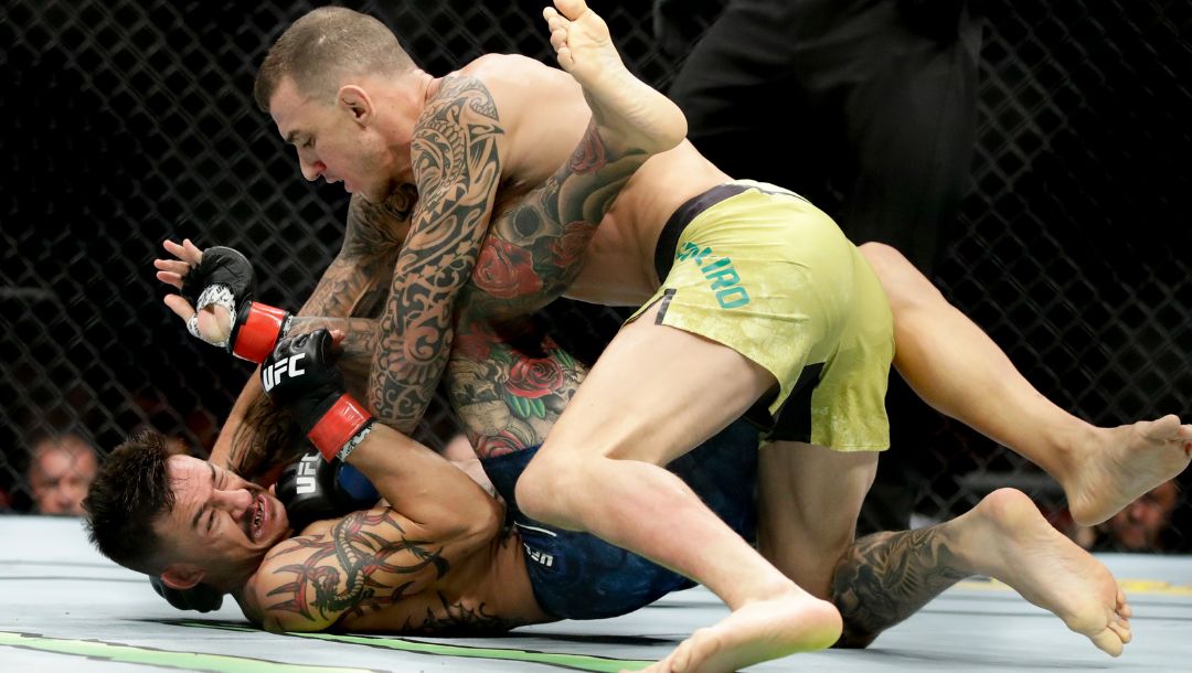 Renato Moicano, top, hits Cub Swanson during their featherweight mixed martial arts bout at UFC 227 in Los Angeles, Saturday.