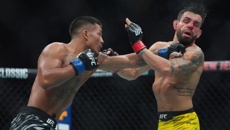 Myanmar's Joshua Van, left, punches Brazil's Bruno Silva during the third round of a light featherweight bout at the UFC 316.