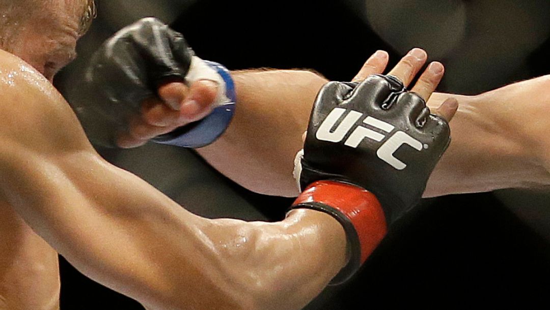 Joe Soto, right, punches T.J. Dillashaw during the second round of a bantamweight championship mixed martial arts bout.