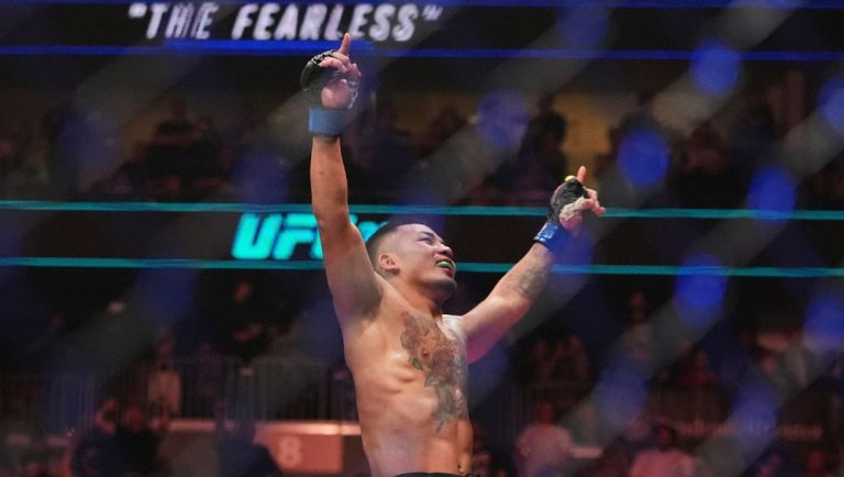 Myanmar's Joshua Van celebrates after stopping Brazil's Bruno Silva during the third round of a light featherweight bout.