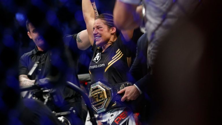 Julianna Pena smiles after defeating Amanda Nunes by submission in a women's bantamweight mixed martial arts title bout.