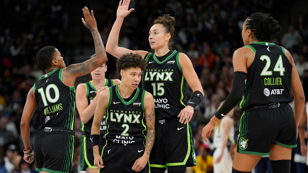 Minnesota Lynx guard Courtney Williams (10) celebrates with teammates during a timeout after making a three-point shot during the first half of a WNBA basketball game against the Dallas Wings, Wednesday, May 21, 2025, in Minneapolis.