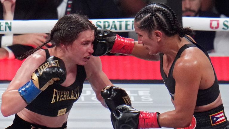 Amanda Serrano hits Katie Taylor during their undisputed super lightweight title bout, Friday, Nov. 15, 2024, in Arlington.