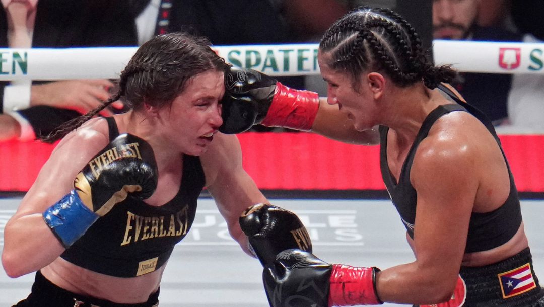 Amanda Serrano hits Katie Taylor during their undisputed super lightweight title bout, Friday, Nov. 15, 2024, in Arlington.