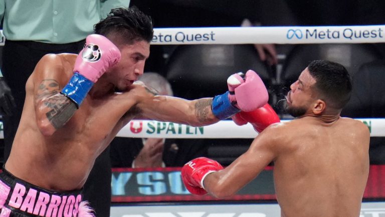 Mario Barrios hits Abel Ramos during a WBC welterweight title bout, Friday, Nov. 15, 2024, in Arlington, Texas.