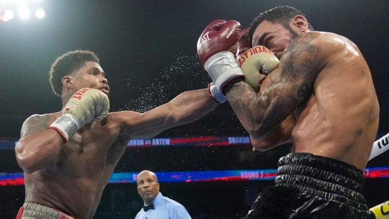 Shakur Stevenson, left, punches Germany's Artem Harutyunyan during the seventh round of a WBC world lightweight championship.