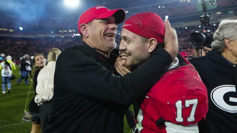 Georgia offensive coordinator Mike Bob and defensive back Dan Jackson (17) celebrate defeating Tennessee in an NCAA college football game, Saturday, Nov. 16, 2024, in Athens, Ga.