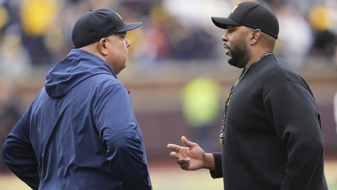 Michigan athletic director Warde Manuel, left, talks with head coach Sherrone Moore, right, before an NCAA college football spring game in Ann Arbor, Mich., Saturday, April 19, 2025.