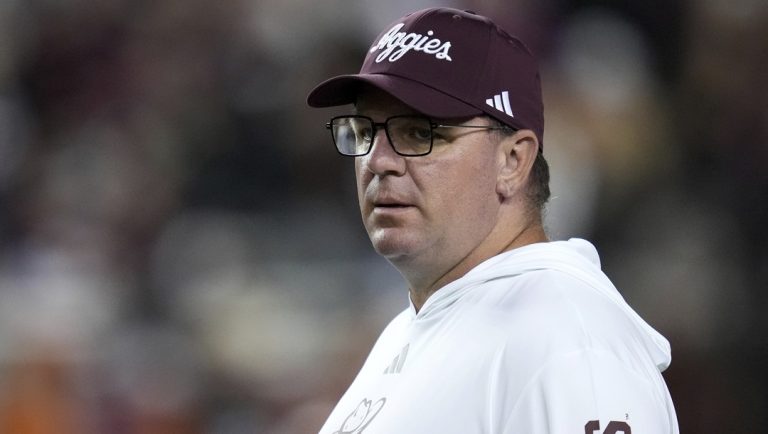 Texas A&M head coach Mike Elko watches his team warm up before the start of an NCAA college football game against Texas on Saturday, Nov. 30, 2024, in College Station, Texas.
