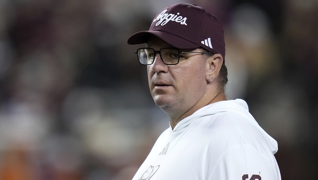 Texas A&M head coach Mike Elko watches his team warm up before the start of an NCAA college football game against Texas on Saturday, Nov. 30, 2024, in College Station, Texas.
