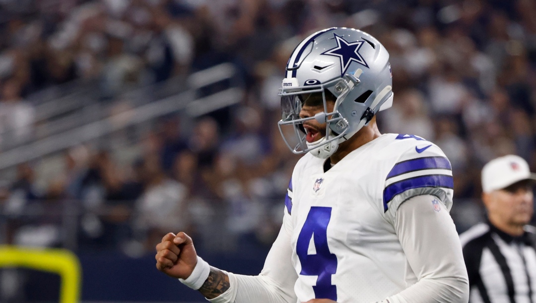 Dallas Cowboys quarterback Dak Prescott (4) celebrates after throwing a touchdown pass to tight end Dalton Schultz in the first half of an NFL football game against the Washington Football Team in Arlington, Texas, Sunday, Dec. 26, 2021.