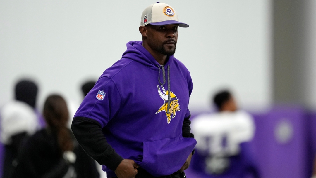 FILE - Minnesota Vikings defensive coordinator Brian Flores stands on the field during an NFL football workout in Eagan, Minn., Oct. 30, 2024.