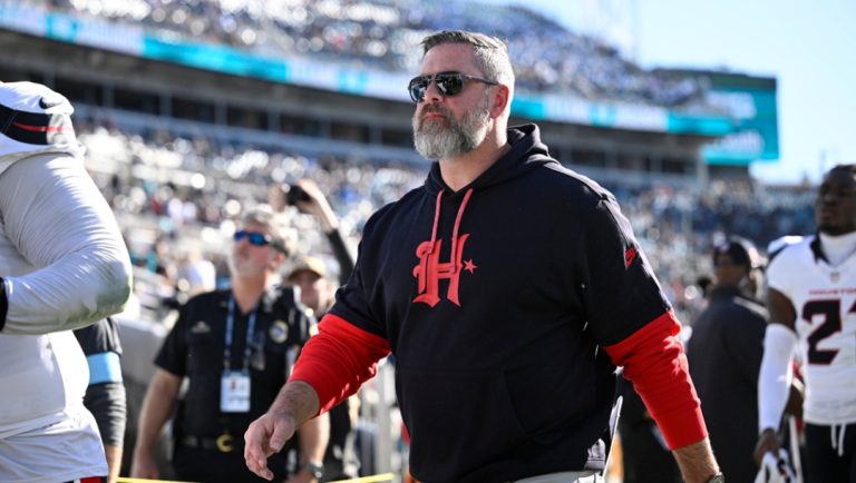 Houston Texans defensive coordinator Matt Burke leaves the field after the first half of an NFL football game against the Jacksonville Jaguars, Sunday, Dec. 1, 2024, in Jacksonville, Fla.