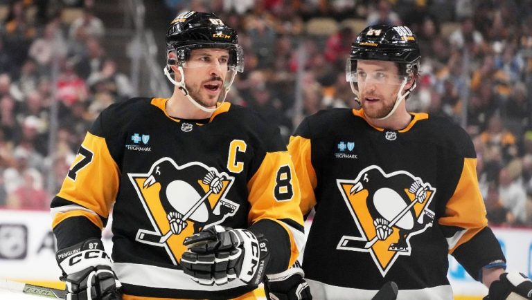 Pittsburgh Penguins' Sidney Crosby prepares to take a face-off with Matt Grzelcyk (24) during the second period of an NHL hockey game against the Washington Capitals in Pittsburgh, Thursday, April 17, 2025.