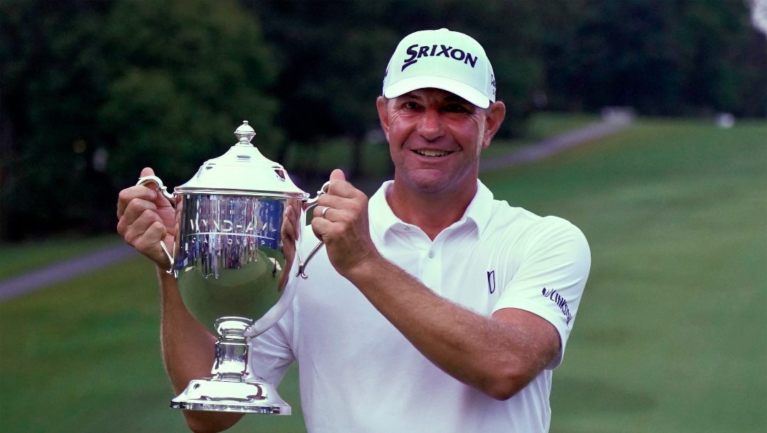 Lucas Glover poses with the trophy after winning the Wyndham Championship golf tournament in Greensboro, N.C., Sunday, Aug. 6, 2023.