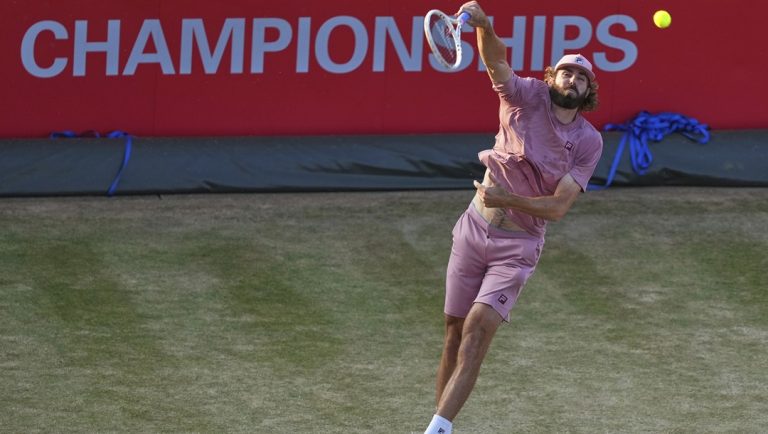 Reilly Opelka, of the United States, serves to Arthur Rinderknech, of France, during the Queen's Club Championships tennis tournament in London, Thursday, June 19, 2025.