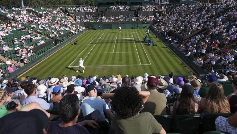 Ben Shelton of the U.S., rear, serves the ball to Alex Bolt of Australia during their first round men's single match at the Wimbledon Tennis Championships in London, Tuesday, July 1, 2025.