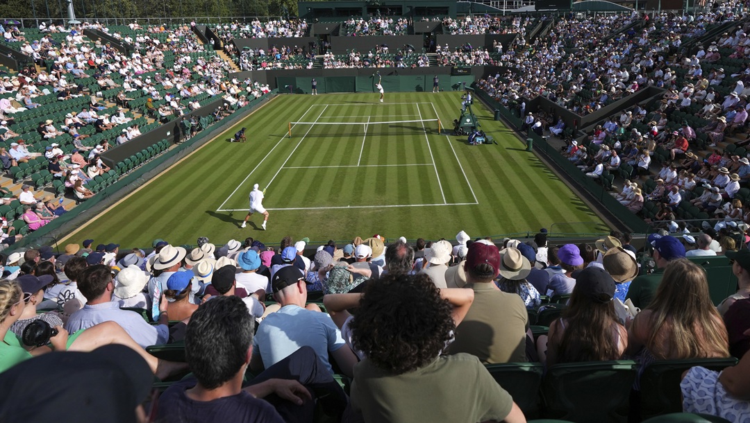 Ben Shelton of the U.S., rear, serves the ball to Alex Bolt of Australia during their first round men's single match at the Wimbledon Tennis Championships in London, Tuesday, July 1, 2025.
