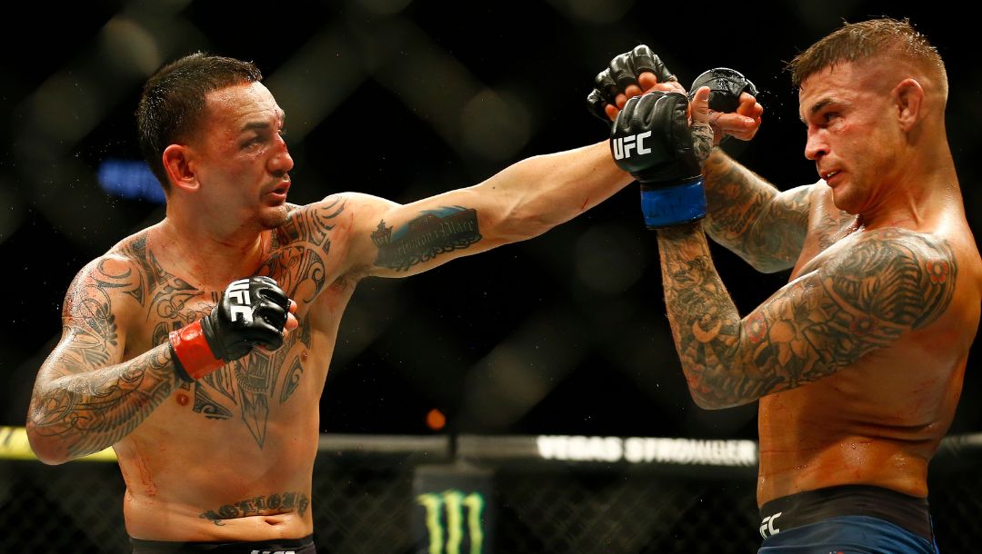 Max Holloway, left, jabs at Dustin Poirier during an interim lightweight title mixed martial arts bout at UFC 236 in Atlanta.