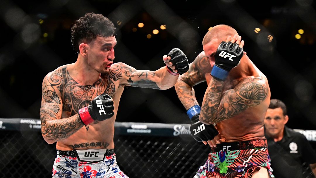 Max Holloway, left, hits Dustin Poirier in a lightweight title fight at UFC 318 in New Orleans, La., Saturday, July 19, 2025.