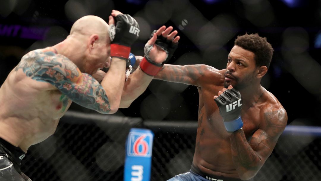 Michael Johnson, right, lands a punch against Josh Emmett during their mixed martial arts bout at UFC Fight Night, Saturday.